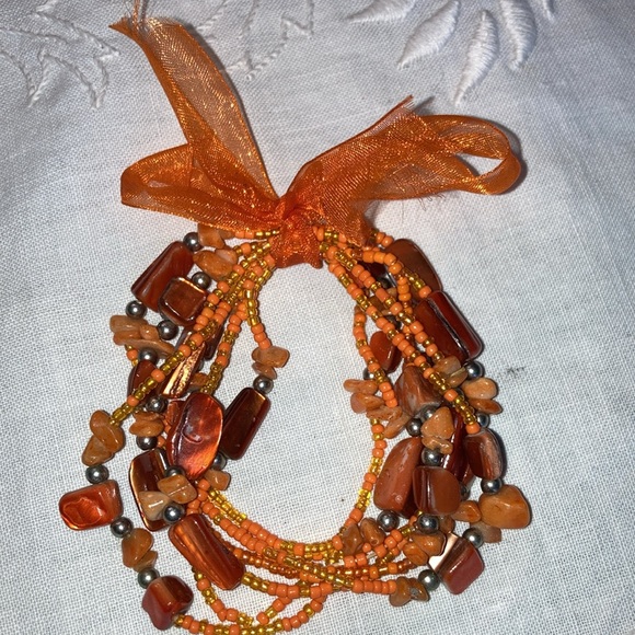 Set of five stretch bracelets with orange beads and seed beads. $15 - Picture 2 of 2